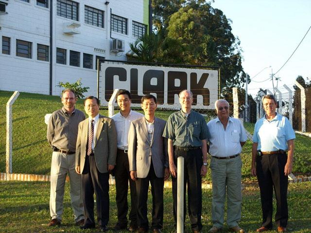 James Song (second from left) visits Clark Material Handling Company (CMHC) in Lexington, Kentucky, for Clark's 90th anniversary celebration. CMHC president Dennis Lawrence is on Song's right.