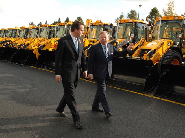 David Cameron walks with Sir Anthony Bamford.