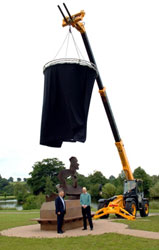 A new sculpture is lowered on the grounds of JCB world headquarters in Rocester.