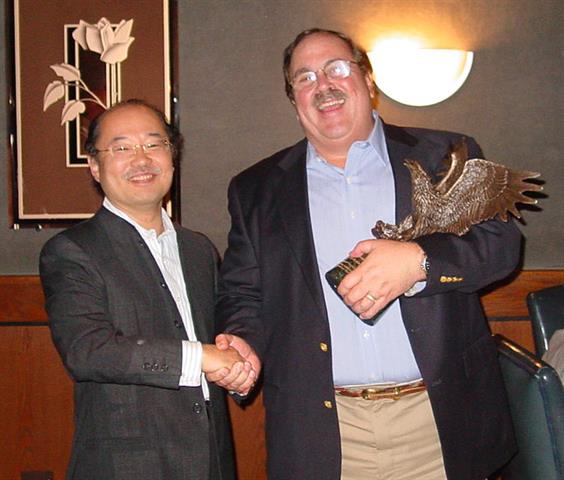 NFC president Tak Tokugawa congratulates Tony Sessa of CFE