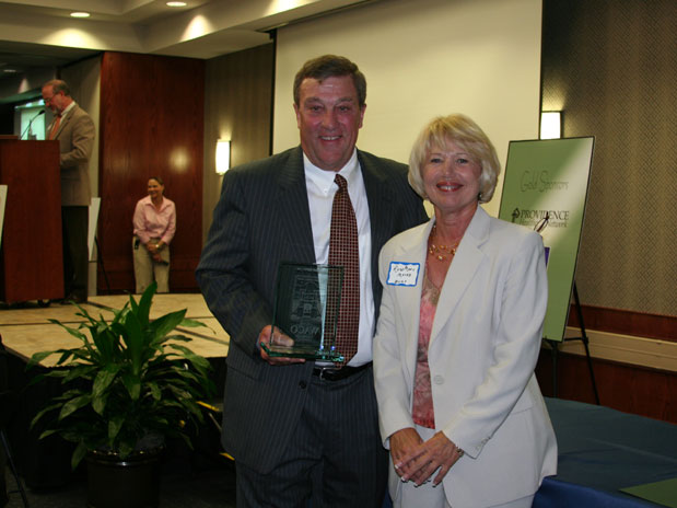 Don Moes, president of Equipment Depot of Texas (left), received the recognition for the firm from RoseMary Mayes, chair of the Greater Waco Chamber of Commerce awards business committee.