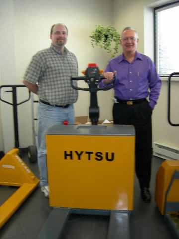 Bob Lemmer (purple shirt) and business partner John Callen, from Global Products, pictured with electric hand pallet truck