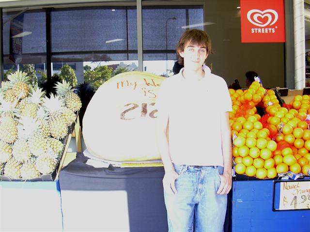 One of the winners posing with the gigantic pumpkin.