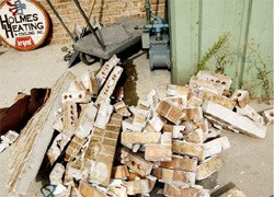 The forklift pulled a safe out of the front of the business by tearing down the wall. - Frank Bott/Daily Herald