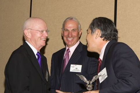 Robert L Wuench (left) receives his ITA meritorious service award from Hideaki Ninomyia (right), of MCFA, and ITA president Jim Malvaso (centre), of Raymond.