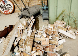 The forklift pulled a safe out of the front of the business by tearing down the wall. - Frank Bott/Daily Herald