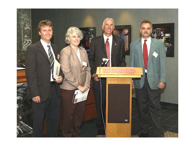 (L to R) John Sauer and Cathy Skoula, from Action Against Hunger; Jim Malvaso, Raymond president and CEO; John Rickard from International Rescue Committee Inc.