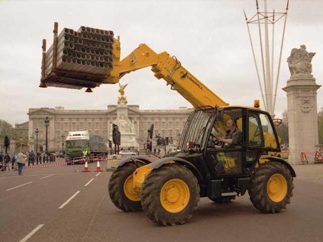 A JCB Loadall telescopic handler working on the finish line of the 25th London Marathon outside Buckingham Palace.