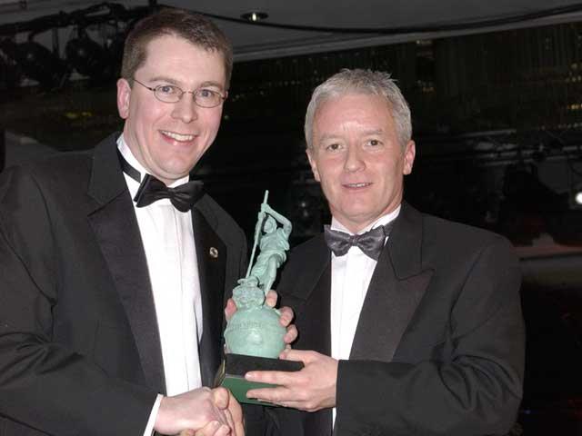 Combilift managing director Martin McVicar (left) receiving the FLTA design award.