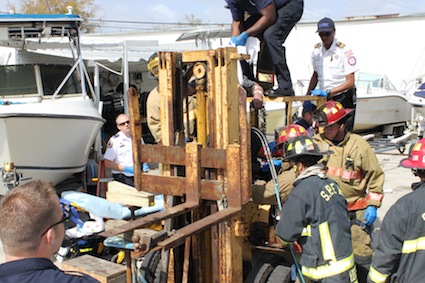 Crew works to rescue mechanic.<br />PHOTO: St Petersburg Fire and Rescue